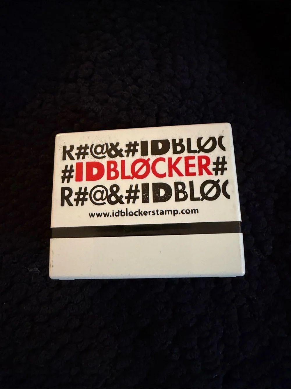White and Black IDBLOCKER Stamp with Red Logo